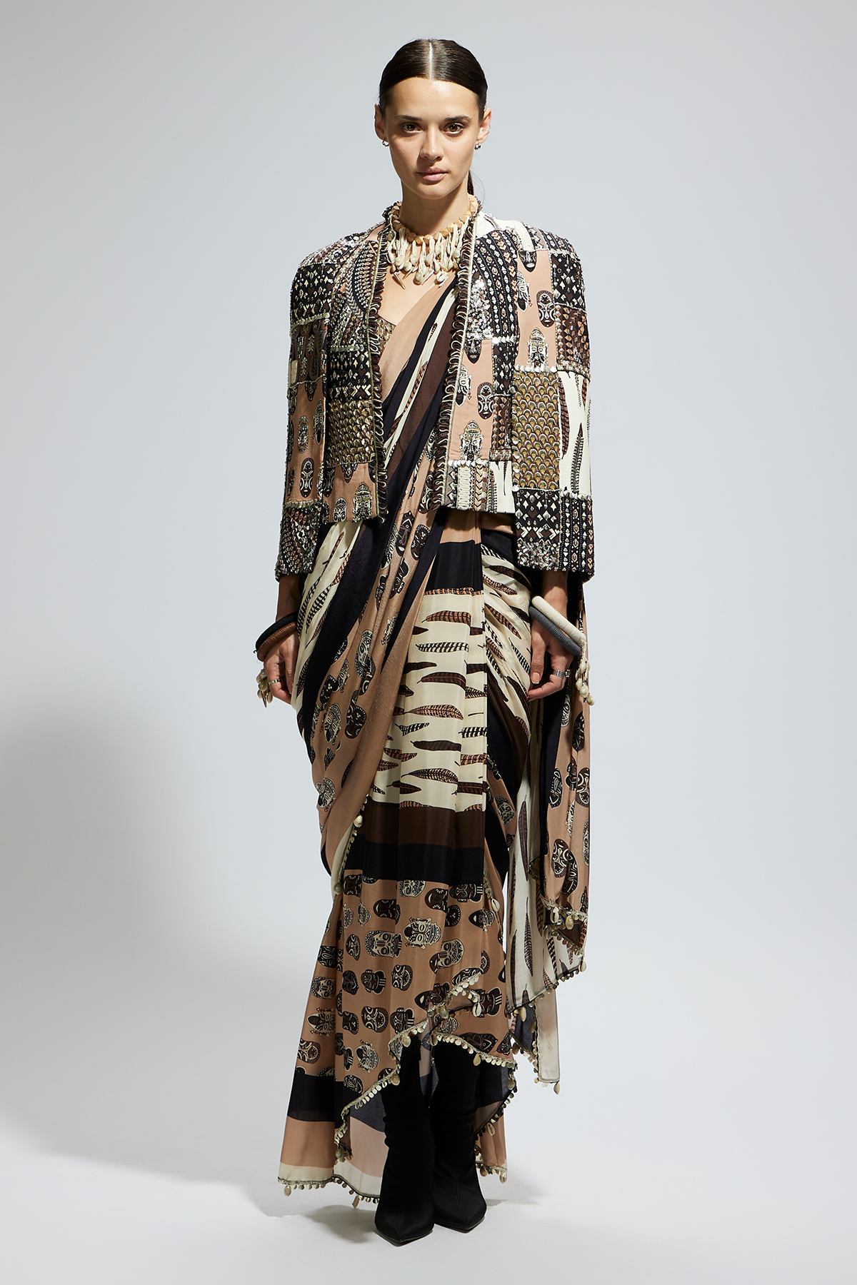 Mask and Feather Print Cascade Saree Paired with Metallic Scallop Bustier with Patchwork Cape Jacket