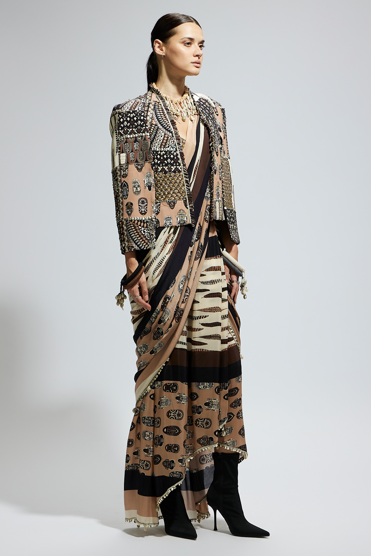 Mask and Feather Print Cascade Saree Paired with Metallic Scallop Bustier with Patchwork Cape Jacket