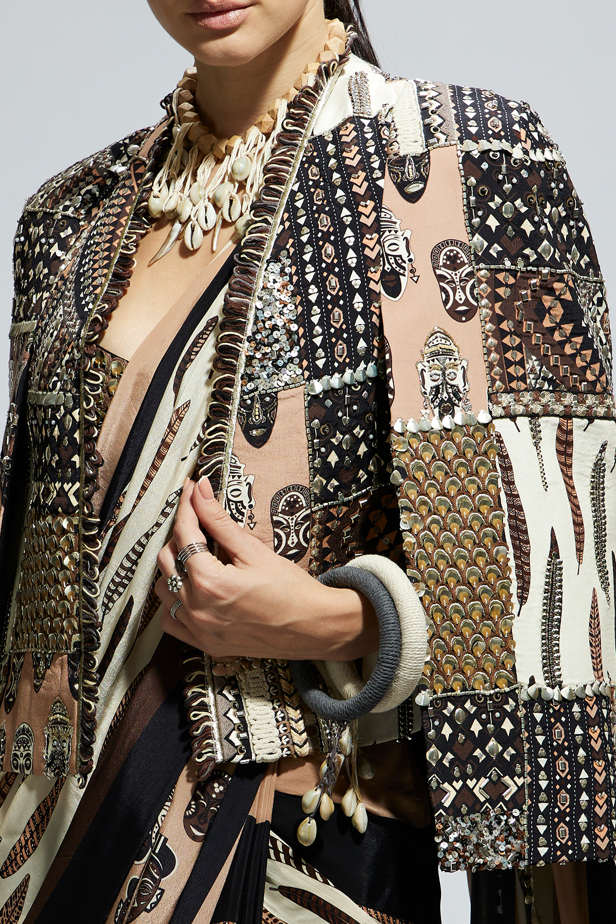 Mask and Feather Print Cascade Saree Paired with Metallic Scallop Bustier with Patchwork Cape Jacket