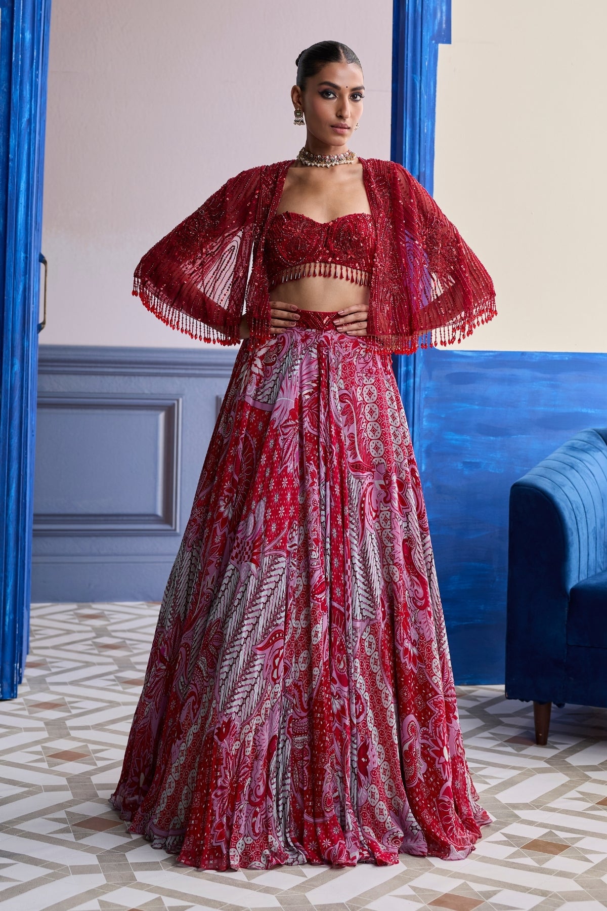RED EMBROIDERED BLOUSE WITH TASSEL CAPE JACKET & FLORAL LEHENGA SET