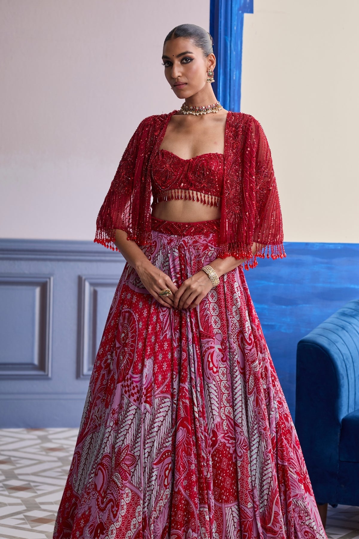 RED EMBROIDERED BLOUSE WITH TASSEL CAPE JACKET & FLORAL LEHENGA SET
