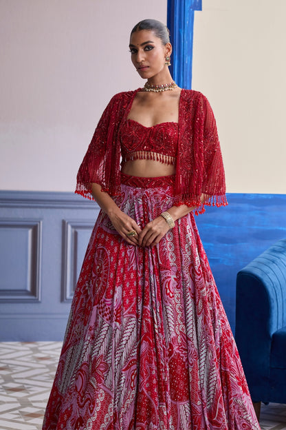 RED EMBROIDERED BLOUSE WITH TASSEL CAPE JACKET & FLORAL LEHENGA SET